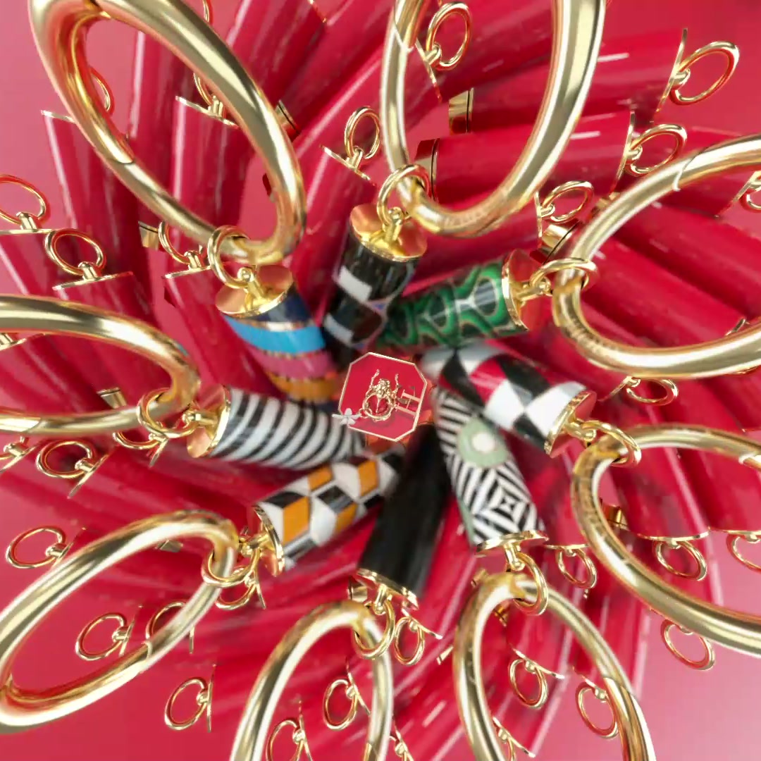 Patterned lipstick cases on gold rings arranged as a burst on red.